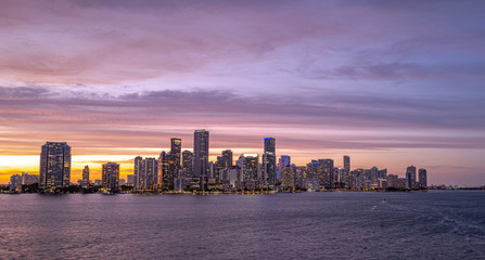 Miami city skyline panorama with urban skyscrapers over sea with reflection. Skyscrapers and harbor.