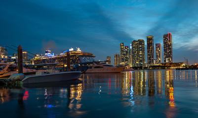 Fototapeta na wymiar Cruise ship and Downtown skyscrapers in Miami. Miami Florida, skyline of downtown night colorful skyscraper buildings. Downtown Miami, Florida, USA.