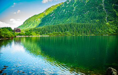 Mountain lake with wooden house - mountain shelter in tatra morskie oko © K.Miłkowski