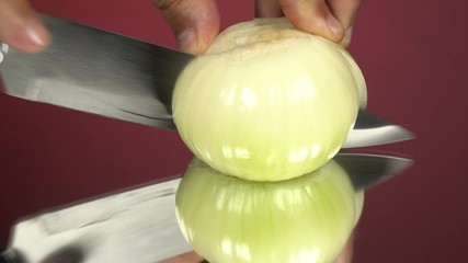 Man cuts onion in a half, the cook makes vegetable salad with onion, man adds onion to the dish