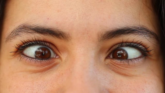 Woman doing cross eye. Close-up person cross-eyed