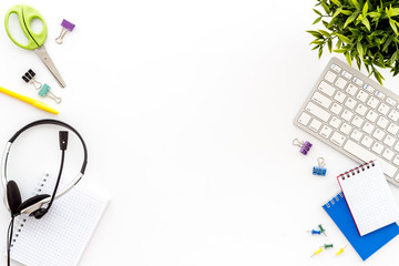 Obraz premium E-learning. Stationery, headphones and keyboard on white table top-down frame copy space