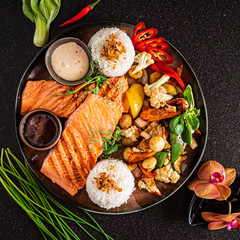 grilled salmon steak with rice and vegetables