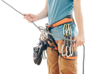 Climber woman in safety harness belaying with rope and figure eight indoor.