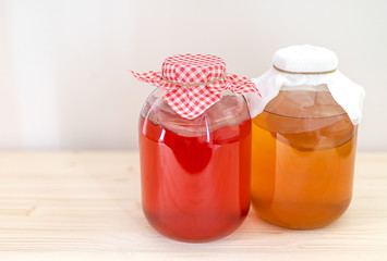 Two big glass jars of homemade fermented kombucha tea. Probiotic, gut healthy drink. Copy space