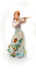 Purchased antique ceramic figurine of a girl with a flute close up isolated on a white background