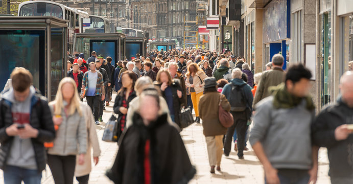 Crowds Of People In The Street, Shopping And Walking On Public Retail Street On A Sunny Day