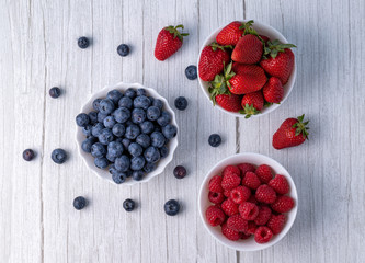 Berries, summer fruits on a wooden table.Blueberries, strawberries, raspberries on the table.