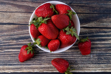 Berries, summer fruits on a wooden table.