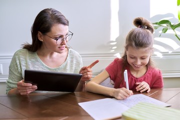 Mother and daughter child study together at home