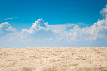 Fototapeta na wymiar View of empty tropical sand beach with puffy white cloud and blue sky background