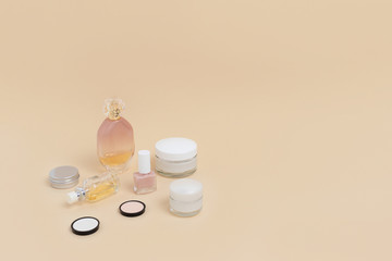 Women's cosmetics on beige background. Beauty concept with copy space.