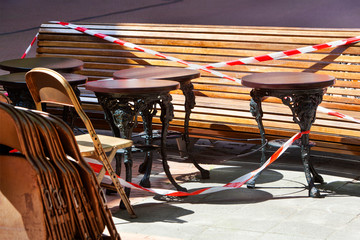 Barrier tape around the empty terraces in Rotterdam during lockdown because of the coronavirus pandemic