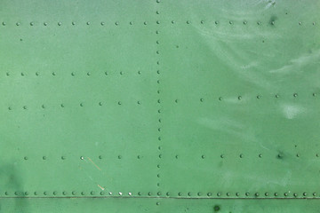 Old aircraft green painted aluminum texture with rivets.