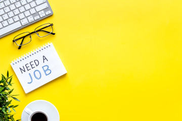 Need a job, looking for. Text on yellow office desk top-down space for text