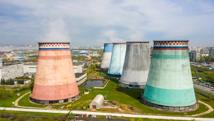 power plant pipes and cooling towers on the background of the panorama of the Moscow city against...