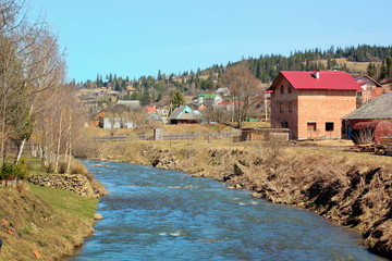 Fototapeta na wymiar rural landscape with river open spaces of western Ukraine beauty of the Carpathian mountain river sunny day warm weather resort village beautiful view best place to staycation 
