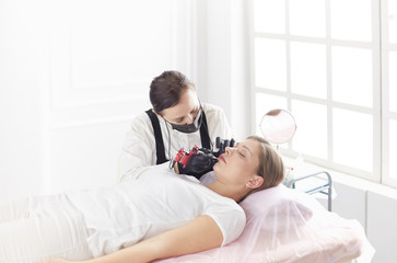 Cosmetologist applying permanent make up on eyebrows