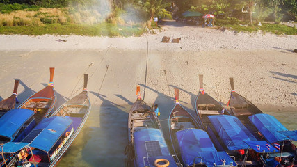 Overhead aerial view of Long Tail Boats on a beautiful topical Thailand beach