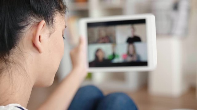 Handheld video of woman having video conference with friends  