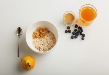 Breakfast is served with coffee, juice, cereals and fruit. Balanced diet. Healthy Breakfast-yogurt with muesli and berries-the concept of health and diet. A Cup of oatmeal granola with fresh blueberry