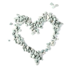 Blue, cyan rocks, pebbles, stones pile arranged in romantic heart shape isolated on white background, top view