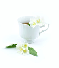 Fototapeta na wymiar Cup of green tea with jasmine flowers isolated on white background.