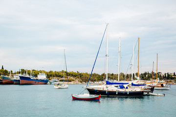 Fototapeta premium many yachts in the anchored bay, yachts are in the marina near the pier, small and large yachts