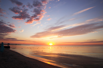 Fototapeta na wymiar Summer sunset on the beach of the sea. Odesa, Ukraine