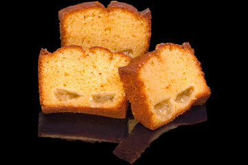 sliced cakes with fruits, isolated on black background, with reflection