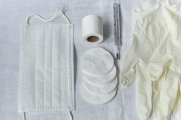 medical masks tablets bottles gloves and gauze on a white background