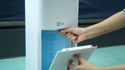 replaced a new filter into the air purifier machine. Preventing allergies. PM 2.5, Dirty air filter need to maintenance.