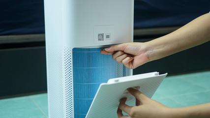 replaced a new filter into the air purifier machine. Preventing allergies. PM 2.5, Dirty air filter need to maintenance.