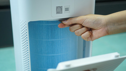 replaced a new filter into the air purifier machine. Preventing allergies. PM 2.5, Dirty air filter need to maintenance.