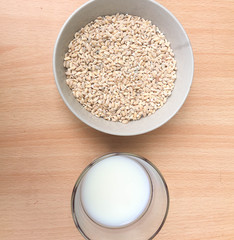 glass of milk and pearl barley porridge on a wooden table milk in a glass in the morning in the village with cereal for breakfast
