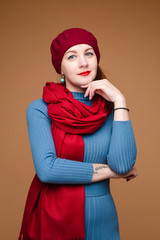 Cheerful woman poses for the camera, picture isolated on orange background