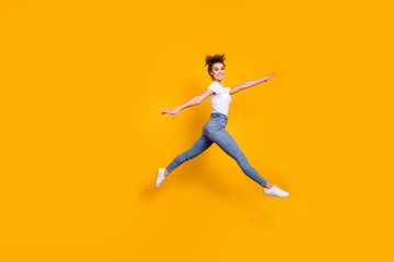 Fototapeta na wymiar Full length body size view of her she nice attractive pretty sporty feminine graceful slender cheerful girl jumping running going walking isolated on bright vivid shine vibrant yellow color background