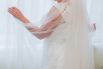 Fototapeta na wymiar wedding veil in the hand of the bride
