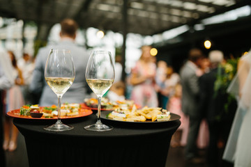 Wedding table with wine glasses and snacks.