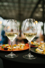 Wedding table with wine glasses and snacks.