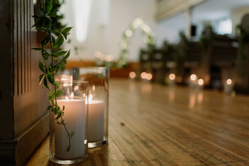 Details of the wedding day. Church Wedding decorations with plants and candles