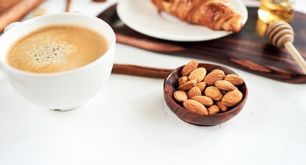 Bowl of almonds on white, for breakfast, selective focus