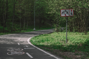 Road sign and Asphalt road in forest.