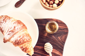 Coffee and croissant with honey. French breakfast. Top view flat lay with copy space for your text
