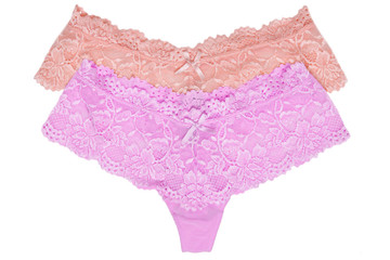 Underwear woman isolated. Close-up of two luxurious elegant pink and violet lacy thongs panties isolated on a white background. Underwear fashion. Front view.