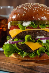 Big sandwich - hamburger burger with beef, tomato, cheese, pickled cucumber and red onion.
