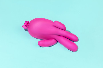 Life of rubber glove - protective wear isolated on blue studio background with copyspace for ad. Must have during pandemic, epidemic, for protection and cleaning. Funny look from the inside.