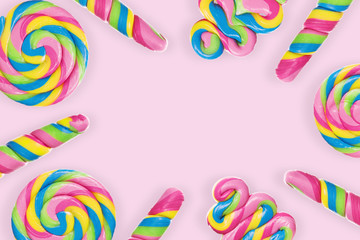 Obraz premium A lot of colorful lollipops , frame with pink background