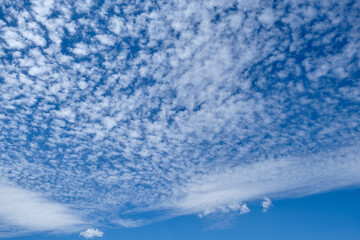 white tiny clouds on blue sky background