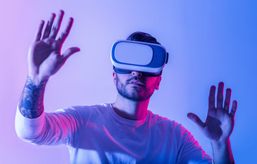 Millennial man in VR with sense of immersion in virtual environment